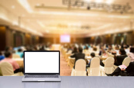 Laptop on desk in seminar room with staffの写真素材