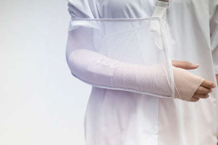 Close-up of female broken arm and wear arm splintの写真素材