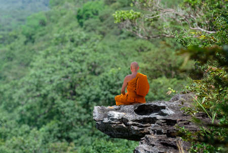 Buddhist monk in meditation at beautiful nature background on high mountain
