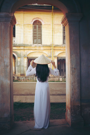 Beautiful woman with Vietnam culture traditional dress, Ao dai, in old residentの写真素材