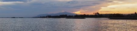 seascape with sunset light and mountain background