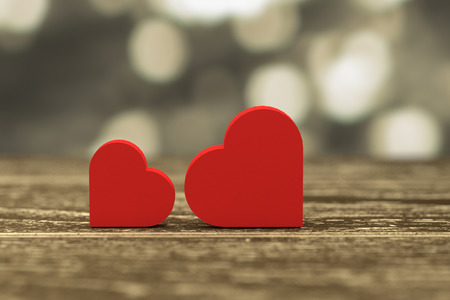 3D rendering - illustration of red heart box put on a wooden table with gold blurred abstract out of...