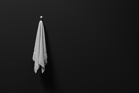 3D rendering : illustration of a piece of clean and white towel hanging on a matt black wall,light and shadow,copy space,3d rendering,dark edgesの写真素材