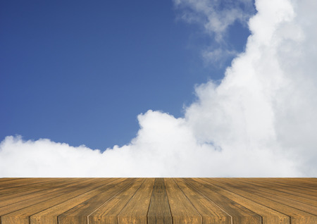 Empty top wooden table and bluesky and clouds in background. Can use for product displayの写真素材