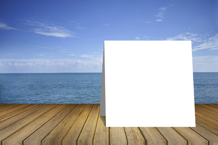 white card on Empty wood table and beautiful peace sea in background. product display template.Business presentation.clipping path includeの写真素材