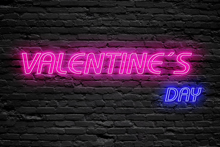 Valentines day. fluorescent Neon tube Sign on dark brick wall. Front view. Can be used for online banner ads or background. night moment.の写真素材