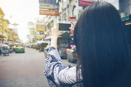 young traveler asian woman using smartphone at Khao San road in Bangkok. Thailand.の写真素材
