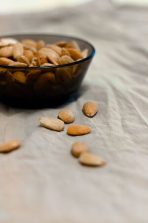Bowl of toasted almonds on a gray backgroundの写真素材