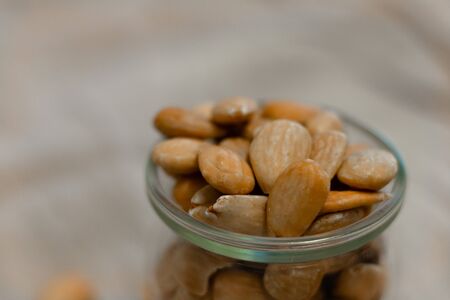 Bowl of toasted almonds on a gray backgroundの写真素材