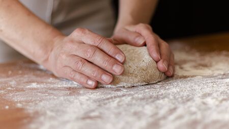 pizza dough on the table with more products to make the pizzaの写真素材