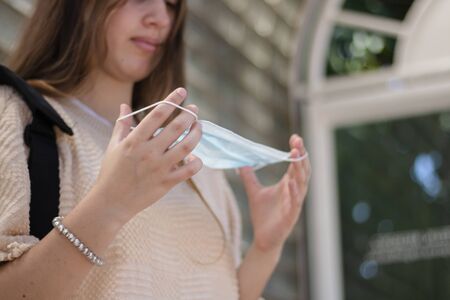 girl putting on mask to avoid virusの写真素材