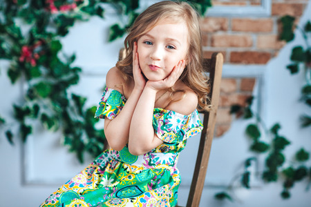 Close-up of a little blonde girl looking and laughingの写真素材