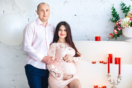 Young future parents on a light background. Pregnancyの写真素材