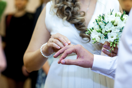 Newly wed couple's hands with wedding ringsの写真素材