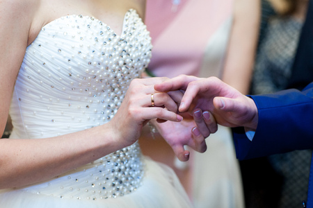 Newly wed couple's hands with wedding ringsの写真素材