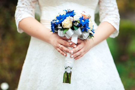 Bride holding beautiful wedding flowers bouquetの写真素材