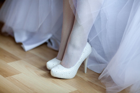 Wedding shoes on the bride's legの写真素材