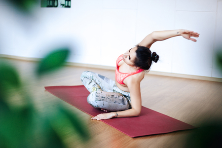 Young woman doing warm-up. Stretching before workの写真素材