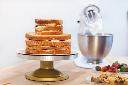 Billet for the cake, mixer and fruit on the table. Ingredients for cake