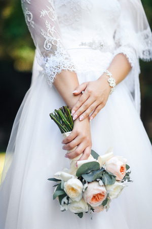 Beauty wedding bouquet in bride's handsの写真素材