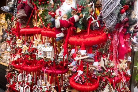 Christmas red decorations paired with cute wooden houses, creating a charming and festive holiday atmosphere.の写真素材