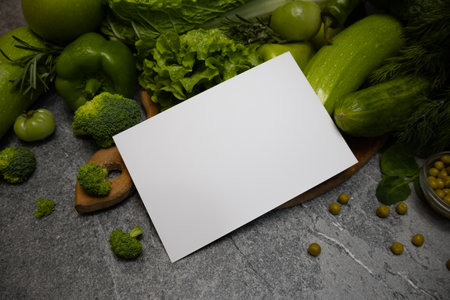 A card message placed on fresh green vegetables, promoting healthy eating and natural food choices.の写真素材