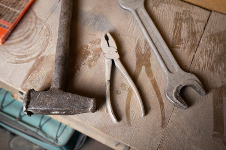 A dusty hammer wrench for repair lying on a shelf, symbolizing tools, maintenance, and construction...