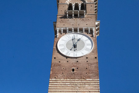 Torre dei Lamberti, the clock tower in Piazza delle Erbe, Verona, Italy, standing tall as a historic...