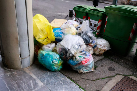 Transparent garbage bags dumped on the street, creating an environmental issue and urban waste problem.の写真素材