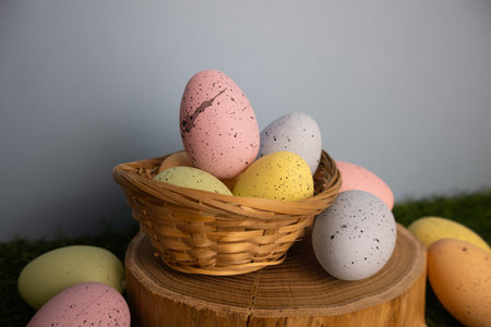 Pastel colorful eggs in a twigs basket with a Happy Easter message, perfect for spring celebrations