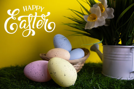 Pastel Easter eggs with daffodil flowers in the background, creating a festive and cheerful holiday atmosphereの写真素材