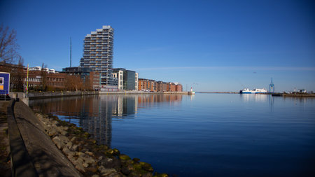 Illustration of office building with corporate business facade near a sea canal in an urban city, reflecting modern architecture and city lifeの写真素材