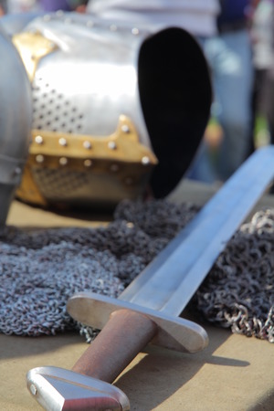 Medieval armor, helmet and sword. Blurred background for textの写真素材