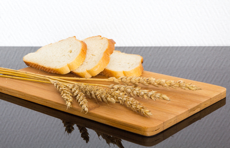 fresh white bread on a wooden Board only the ripened wheatの写真素材