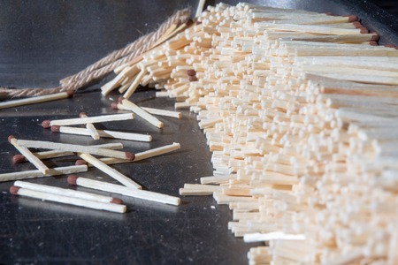 a lot of matches stacked exactly on a dark surfaceの写真素材