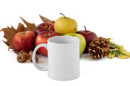 A closeup shot of a white mug and apples on white background. Mockup scene.の写真素材