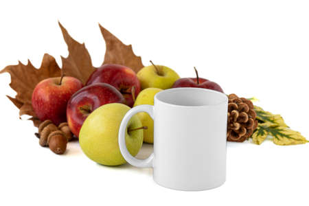A closeup shot of a white mug and apples on white background. Mockup scene.の写真素材