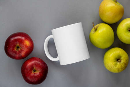 A closeup shot of a white mug and accorns on white background. Mockup scene.の写真素材