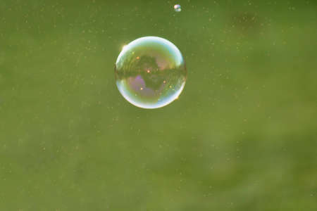 Lonely Colorful Soap Bubble with Reflection of the City and Sky Inside Itの写真素材