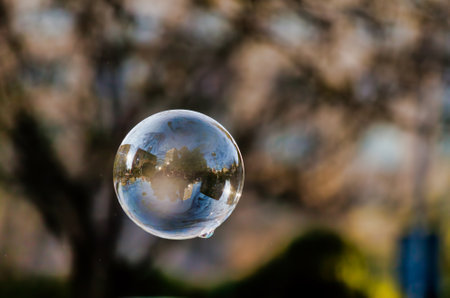 Lonely Colorful Soap Bubble with Reflection of the City and Sky Inside Itの写真素材