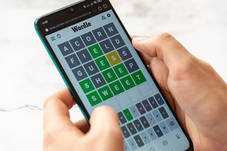 A man plays the WORDLE game on the New York Times website - Bucharest, Romania, March 2022のeditorial素材