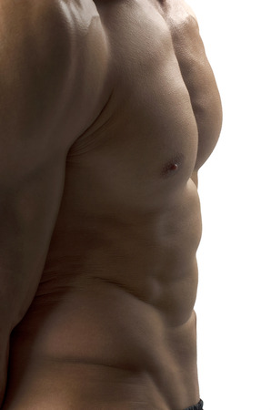 Strong bodybuilder man with perfect abs, shoulders,biceps, triceps and chest, personal fitness trainer flexing his musclesの写真素材