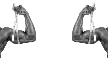 Close up on a bodybuilder biceps,shoulder,arm with measuring tapeの写真素材