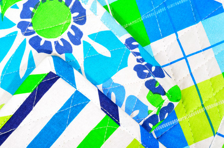 Color stripes quilted and floral pattern on fabric.の写真素材