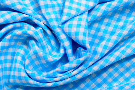 Checked print as background. Little squares pattern on crumpled fabric.