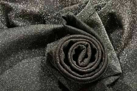 Crumpled grey and silver sparkly textured fabric.の写真素材