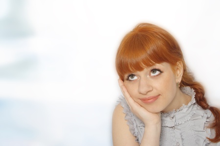 Portrait of happy young woman smiling and posing against white background