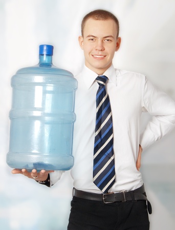Successful young businessman presenting a water bottleの写真素材