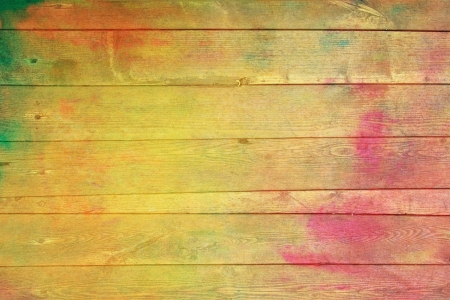 Old wooden painted wall: Abstract textured background with red, yellow, and green patterns. For art texture, grunge design, and vintage paper / border frameの写真素材