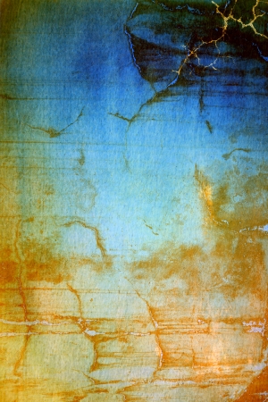 Old ragged wall  Abstract textured background with yellow and brown patterns on blue backdrop  For art texture, grunge design, and vintage paper   border frameの写真素材